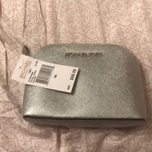Make up case by Michael Kors in sliver.